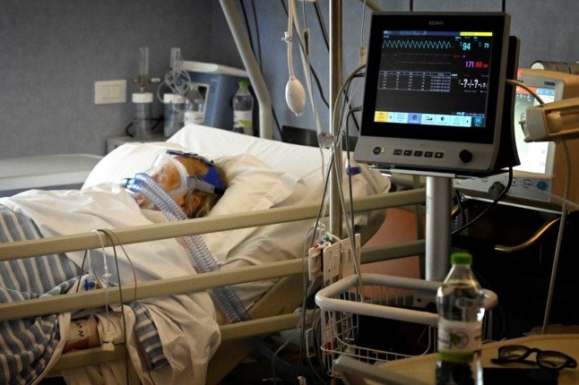 A Covid patient breathes oxygen through a mask at the sub-intensive care unit of the Casalpalocco hospital, south of Rome, on October 13, 2021.