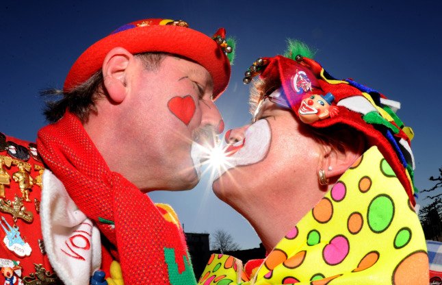 Deux fêtards de Karneval partagent un baiser lors du Rosenmontag.
