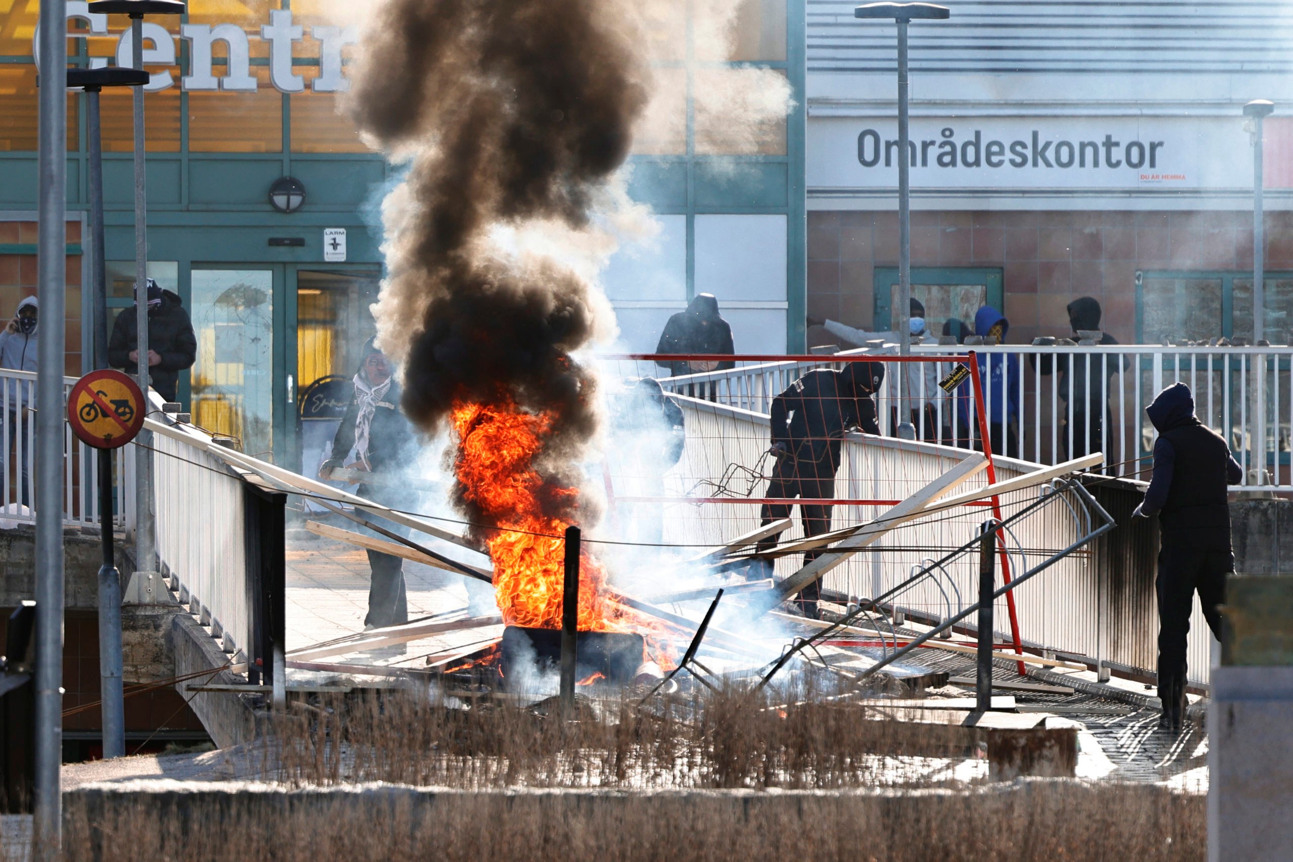  Les gens font une barricade avec des pneus de voiture brûlés et d'autres objets au centre de Ringdansen, en lien avec les émeutes à Navestad à Norrköping le jour de Pâques